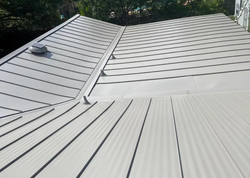 Solar attic fan installed on a metal roof for Roof Ventilation in Franklin Park